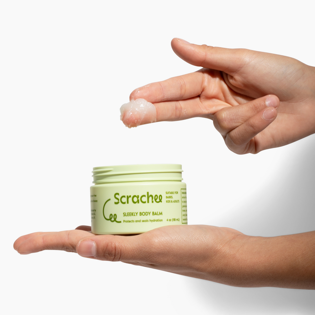 Person applying Scrachee body balm to their hand with a white background