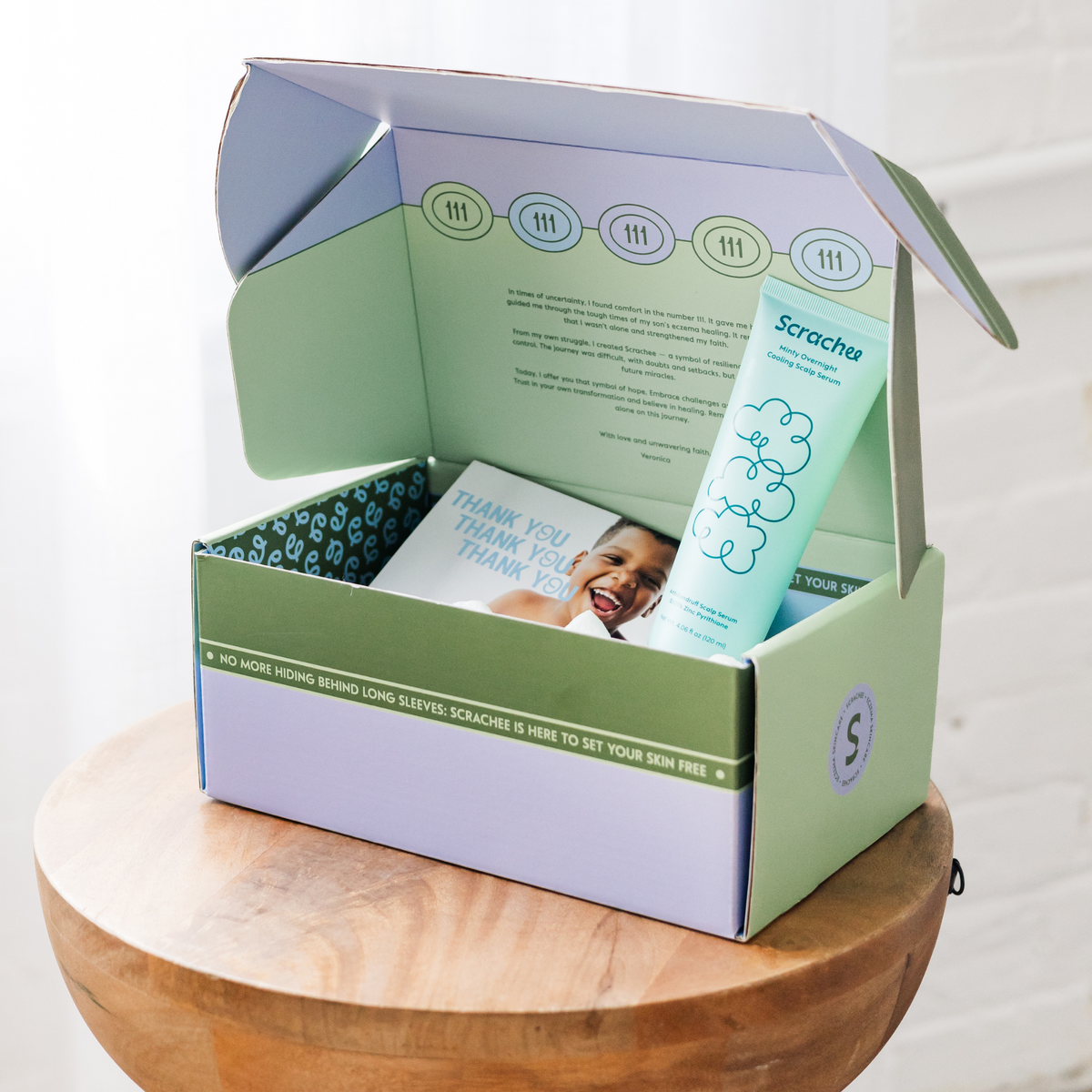 A box of Scrachee with a scalp serum inside. 